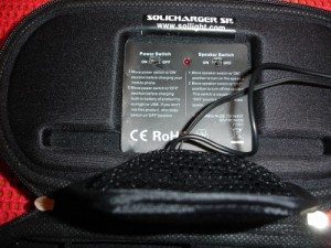 Close-up of the control panel. The LED shows that the speaker switch is 'on'. Also shows the pouch.