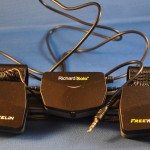 FreeWheelin attached to clip with round charging cable.
