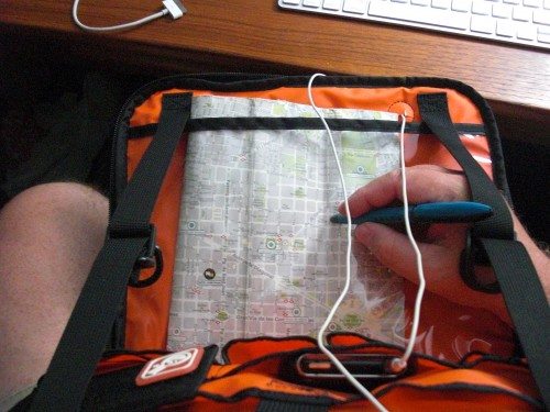 Placement of the headphone pass-through port means the wires are streatched across your field of view twice when looking at a map. Note the heavy straps and D-rings that cannot be unclipped or removed.