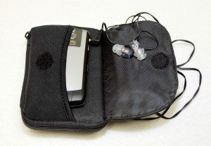 Earbuds attached to device for portable listening.