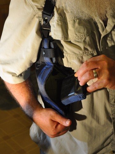 Right-side holster, showing iPhone 4s strapped in above lower pocket with Waterfield wallet being inserted.ld