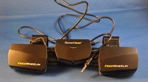 FreeWheelin attached to clip with round charging cable.