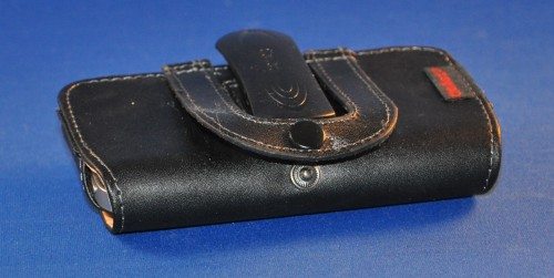 Top of case with sewn-on belt strap unsnapped.