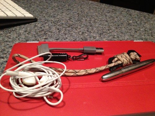 It all fits - Apple Earbuds, Encase USB-30-pin cable, Fisher Space Pen, Gerber Shard with paracord wrapping, Streamlight Nanolight.