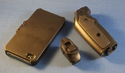 The main pieces of the Grip & Shoot. On the left is the phone holder (this one contains my iPhone 4s. There's also one for an iPhone 5 in the package.) On the right it the handle, which has two thumb-operated buttons for zoom on the angled top piece near the center, and a shutter trigger in front of the top grip screw. (The grips are a soft, very comfortable rubberized material.) The small piece in the lower center is normally clipped into the handle, but it can also be used to hold the camera-phone, while the rest of the handle can be used to zoom and shoot hands-free.