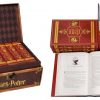 Pick up a trunkful of hardcover Harry Potter books in dust jackets designed for each house at Hogwarts