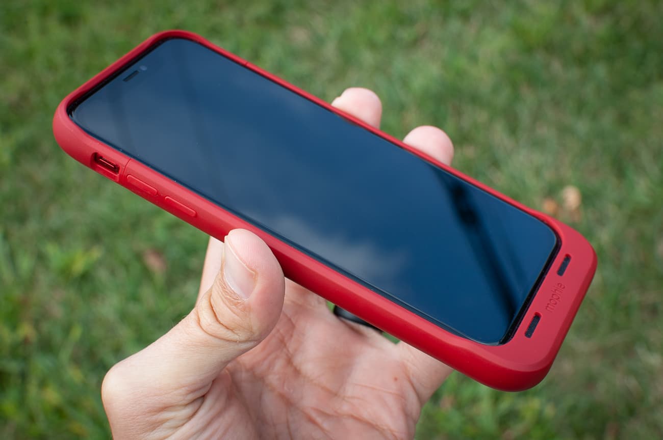 hand holding an iphone with a red juice pack air phone case