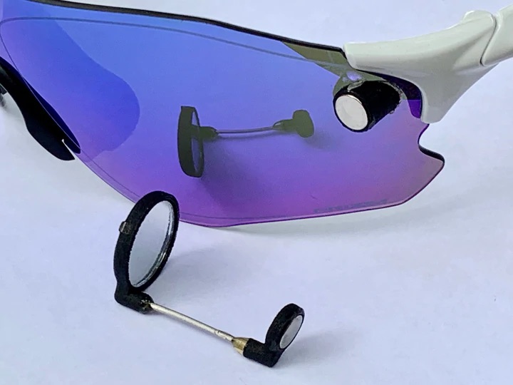 This mini rearview bicycle mirror attaches directly to your glasses The Gadgeteer