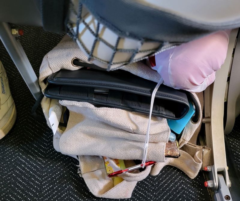 How to hang a small sling bag off the seat back pocket on a plane :  r/TravelHacks