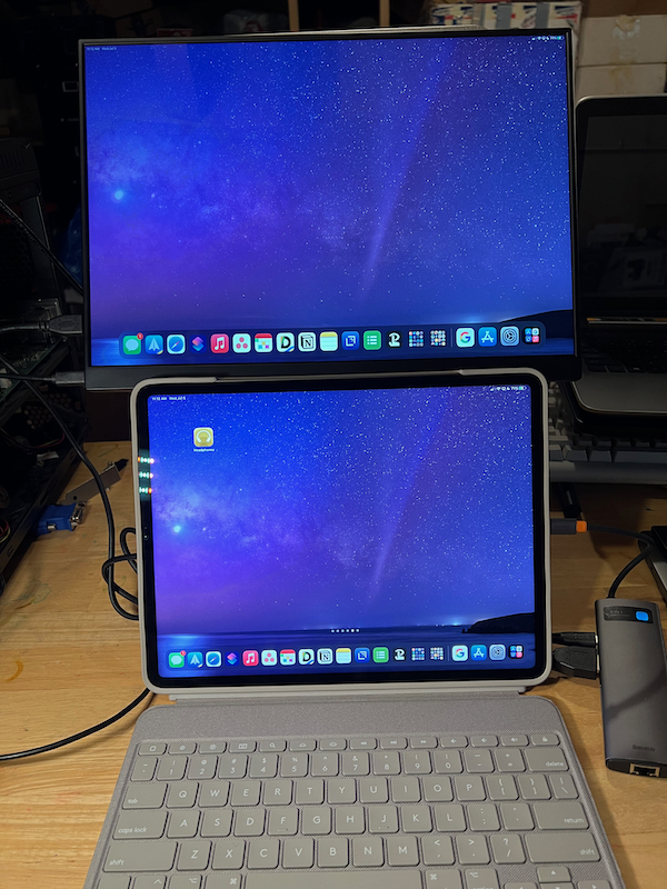 iPad Pro setup with USB-C dock and separate mini HDMI and USB-C cables going into monitor
