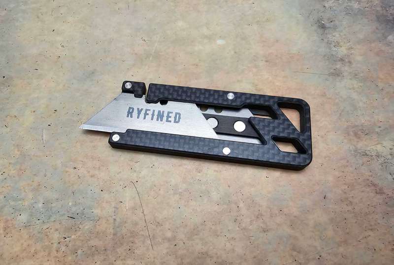 a black and silver utility knife