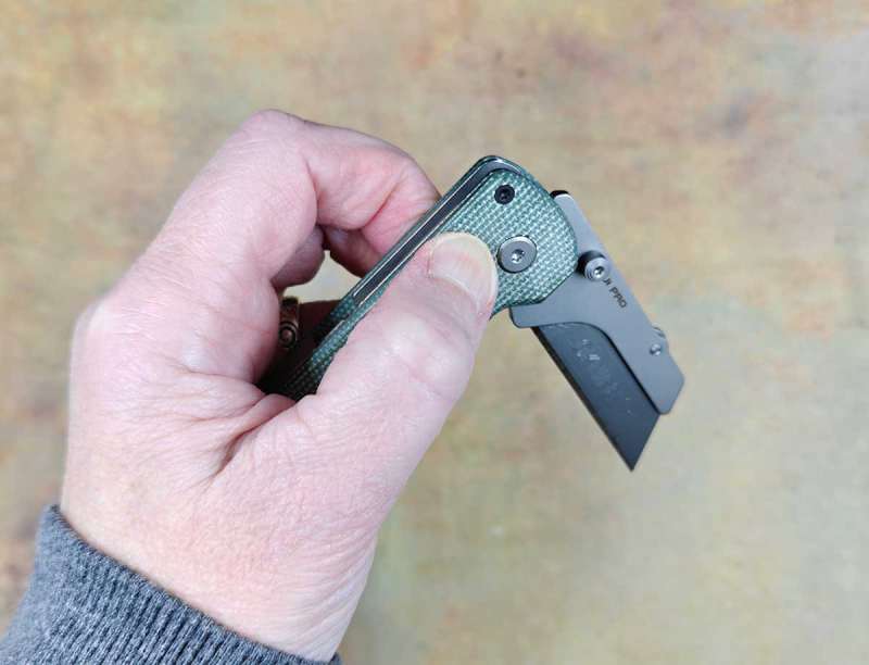 a hand holding a folding knife