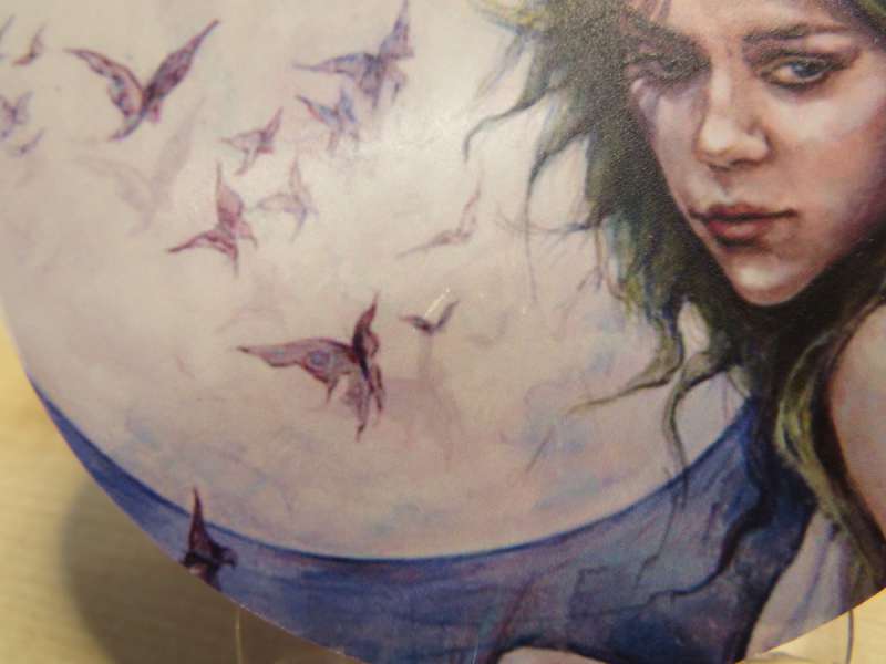 These little scratches are minor, but for products you're selling, it's enough to necessitate a protective layer over the print. Image: Tarot of the Hidden Realm