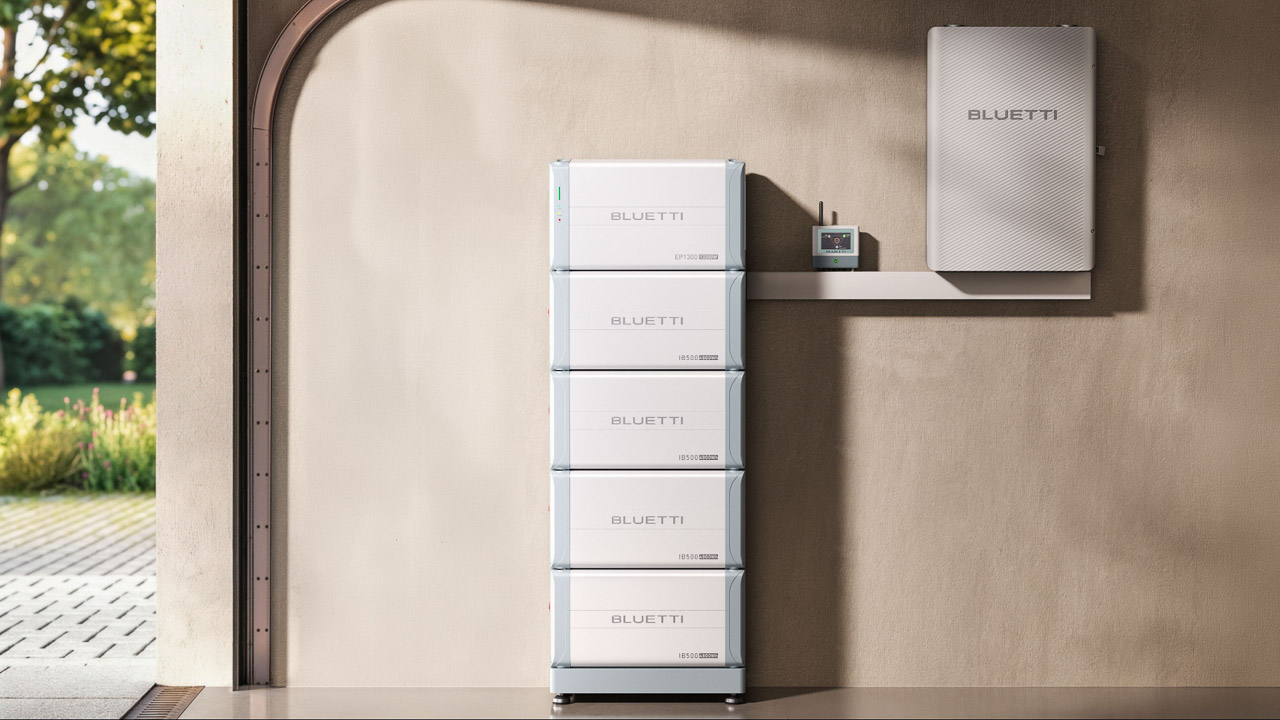 A sleek, white BLUETTI EnergyPro 13K whole home battery backup system installed against a modern garage wall next to a parked electric vehicle.