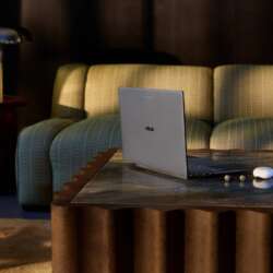 ASUS Googlebook 14 on a coffee table beside a sofa