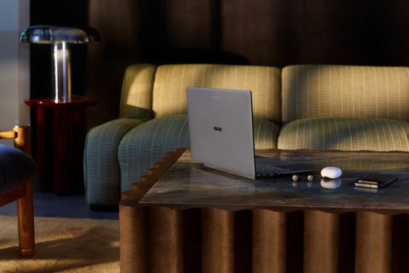 ASUS Googlebook 14 on a coffee table beside a sofa