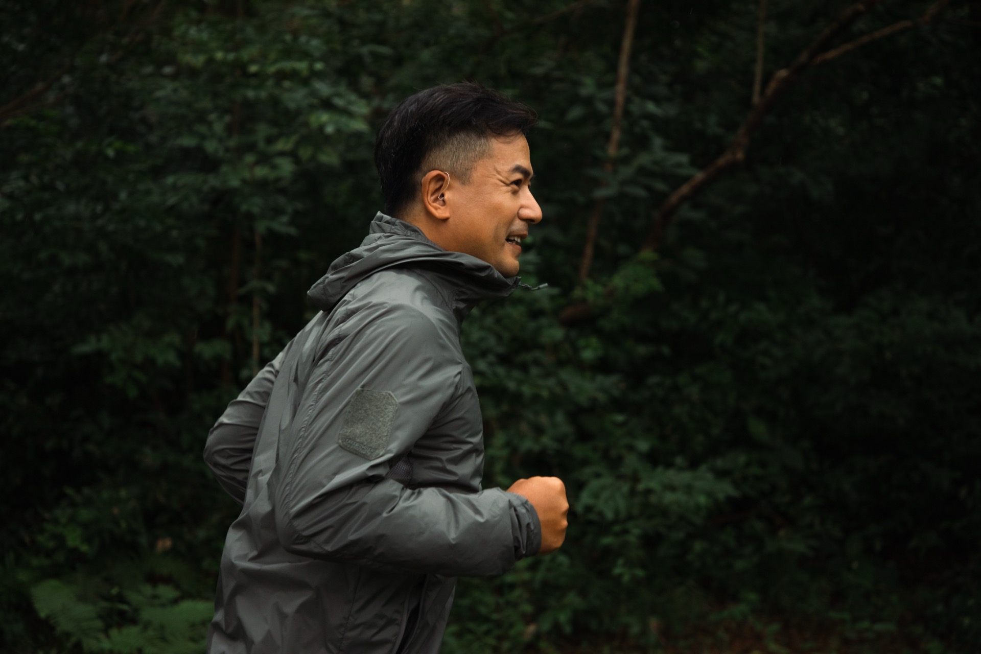 A runner wearing a Beyond 2 Pro hearing aid outdoors.