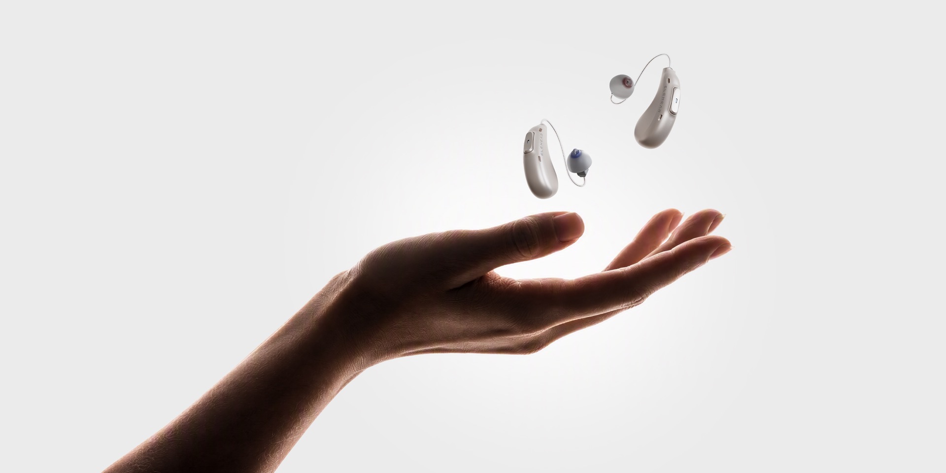 Beyond 2 Pro hearing aids shown above an outstretched hand.