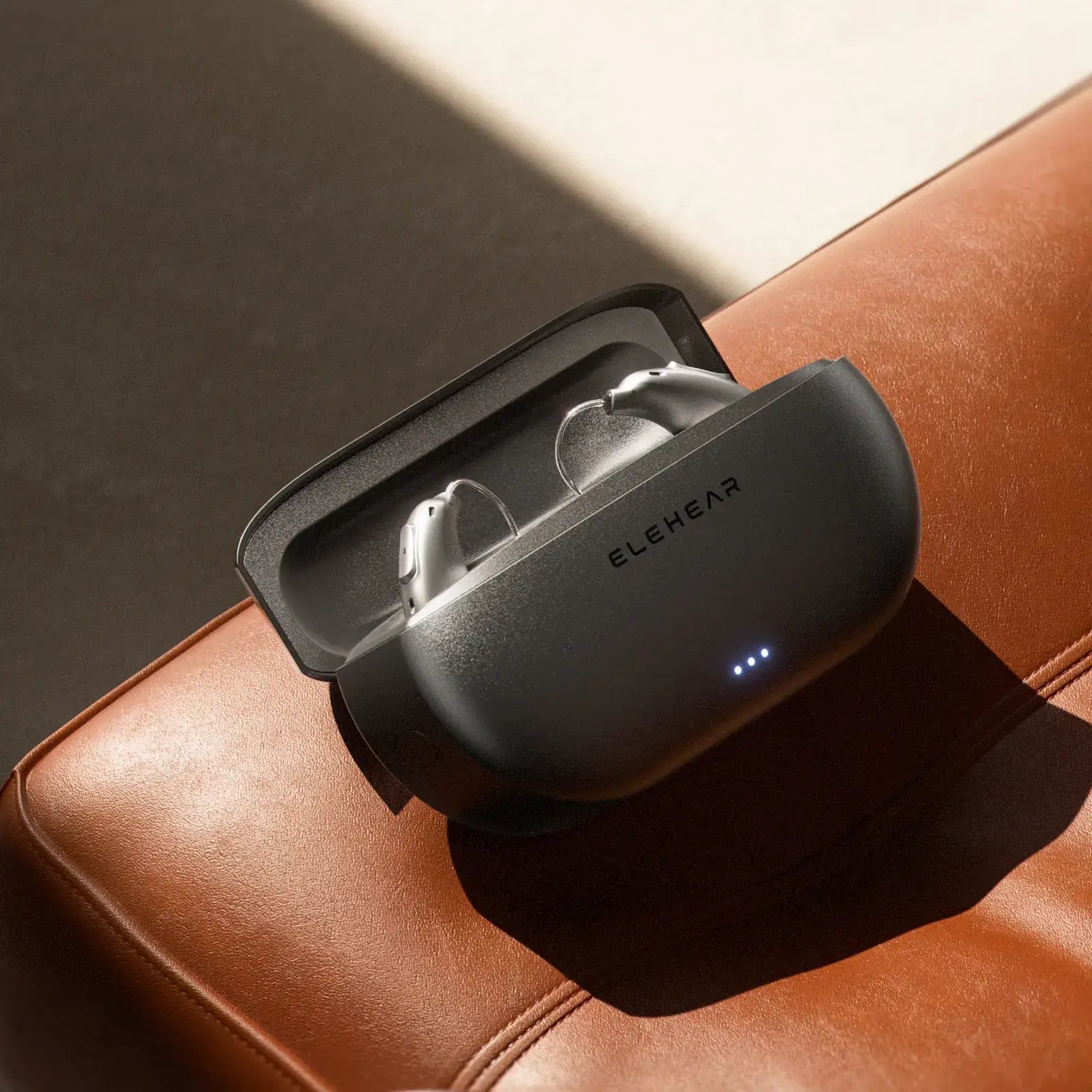 Original ELEHEAR Beyond Pro hearing aids in a silver charging case.