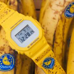 Yellow BAIT Yamagata's Finest G-Shock DW5600 lying across ripe bananas.