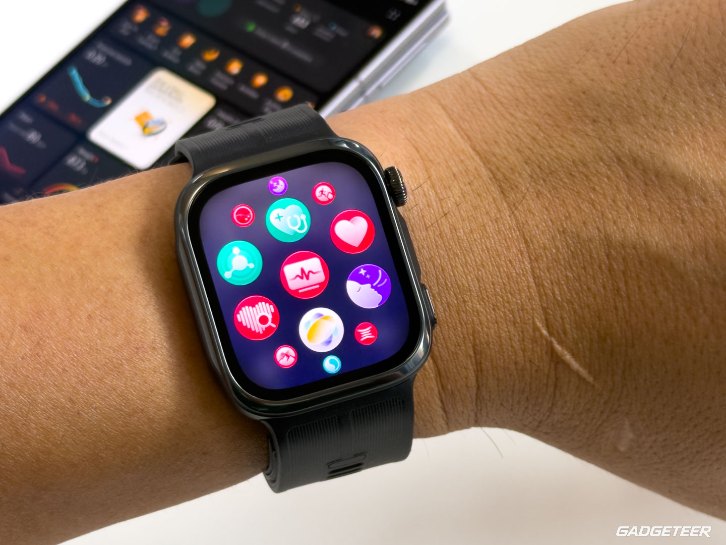 Huawei Watch D3 on Vincent’s wrist showing the app grid with a phone behind it