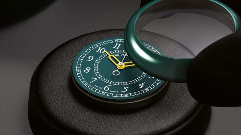 Green ceramic Louis Vuitton Monterey case being fitted over its green dial during assembly.