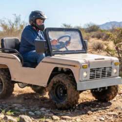 Cream Massimo Mini Truck with a helmeted rider on a dirt trail