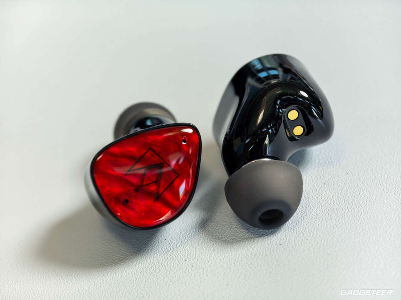 Noble FoKus Amadeus earbuds showing the red faceplate, black shell and silicone ear tip