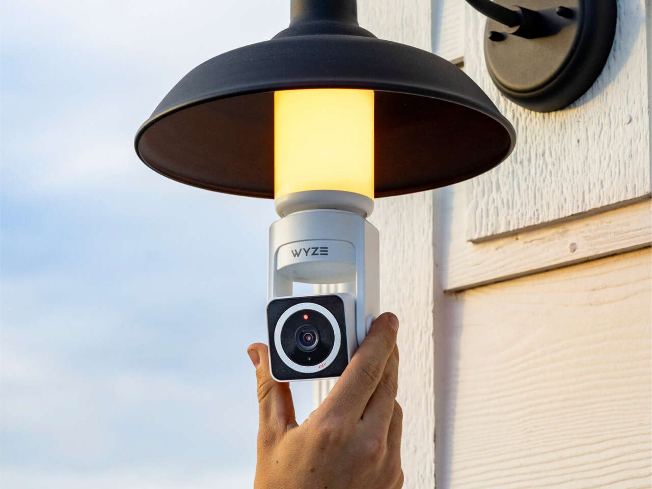 A Wyze Bulb Cam Pan Color beneath an open outdoor light fixture.