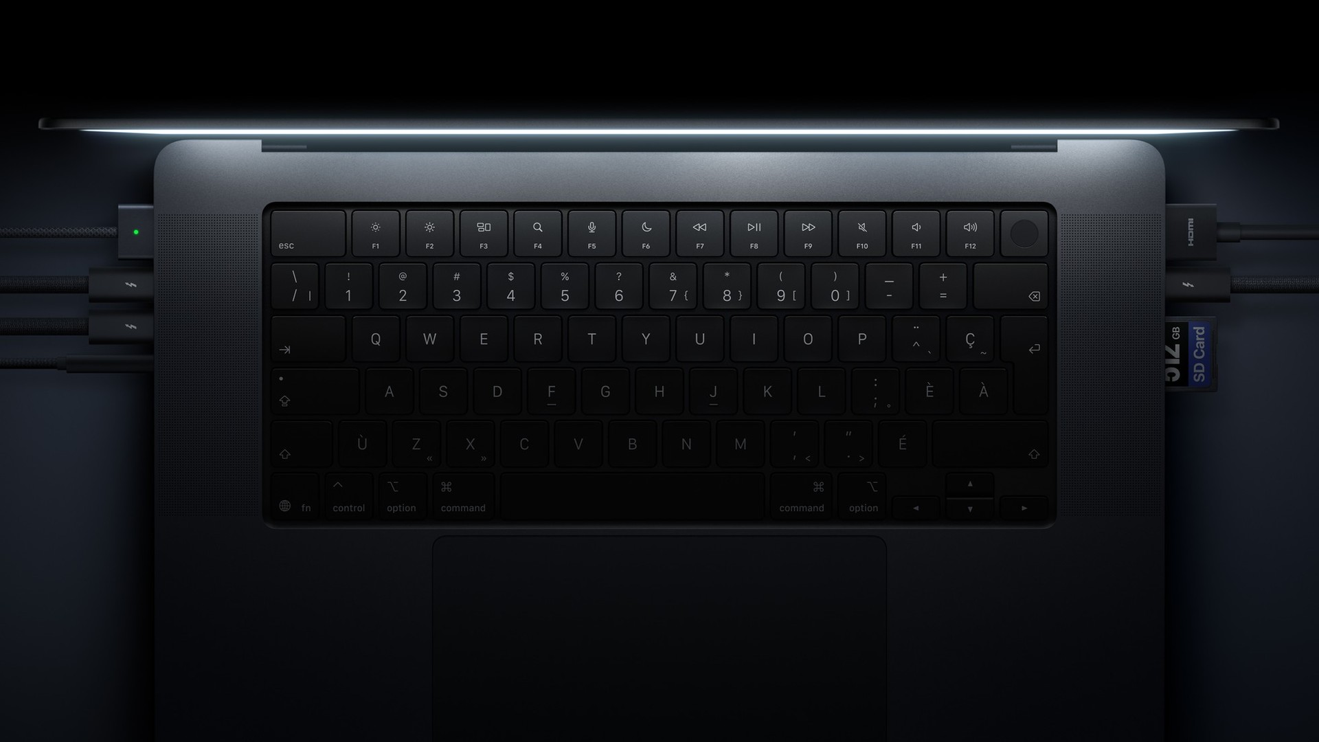 A close-up of the keyboard and ports on MacBook Pro with PROLED XDR Display.