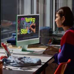 A green M6 iMac on a desk beside a person editing a sewing tutorial.