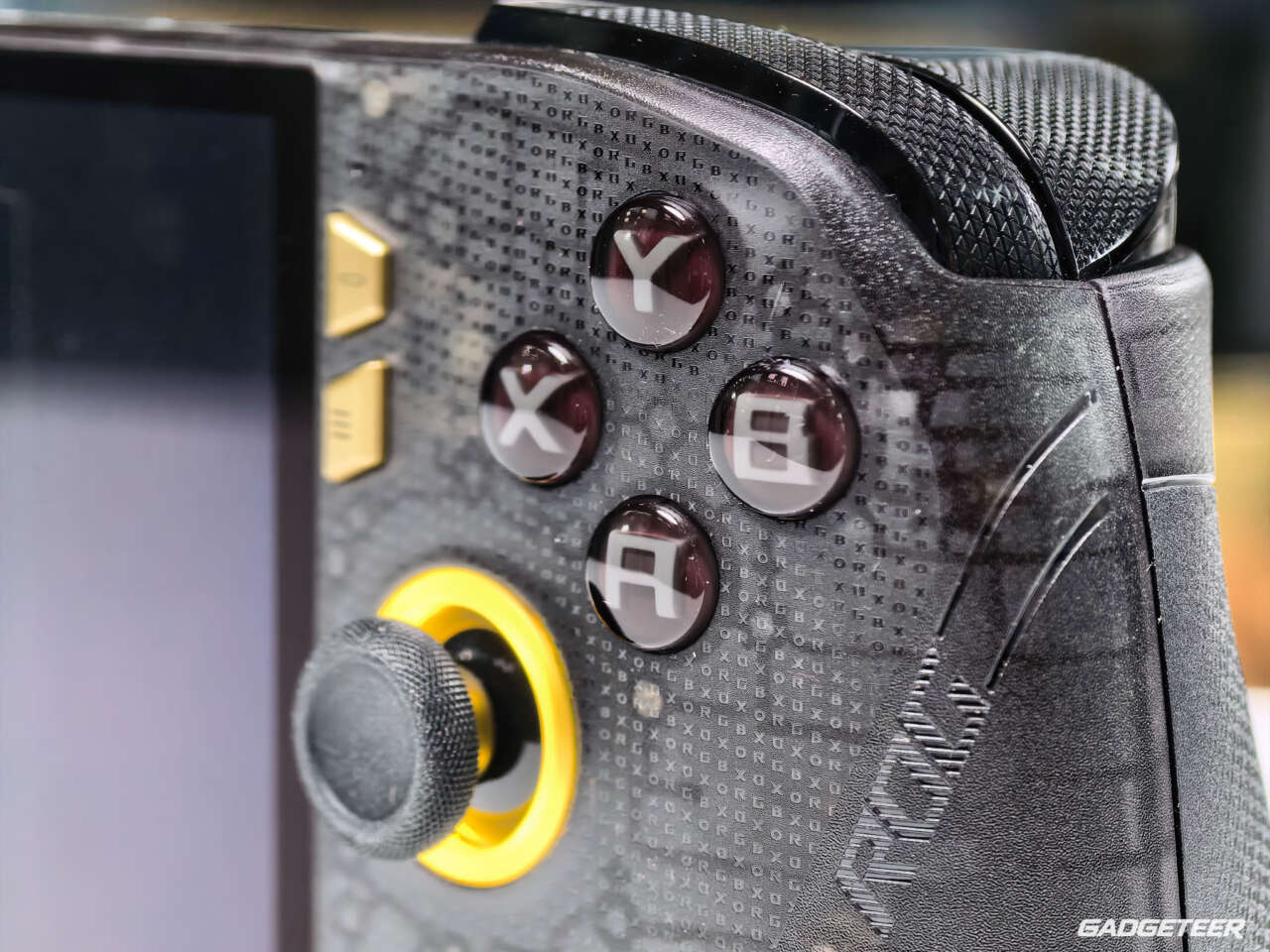 Gold-ringed right thumbstick and ABXY buttons beside the textured right grip.