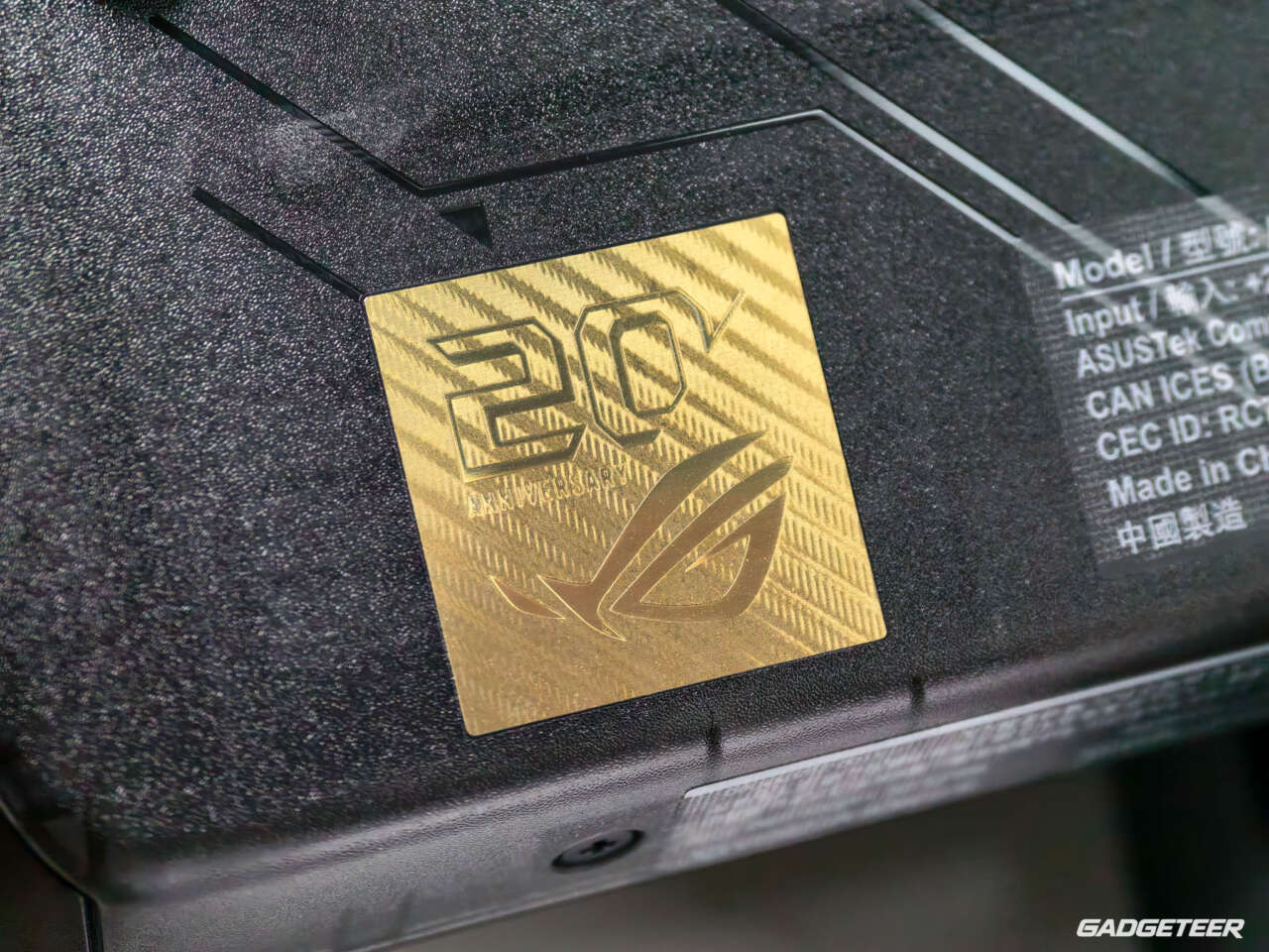 Gold twentieth-anniversary emblem on the translucent black ROG Xbox Ally X20 shell.