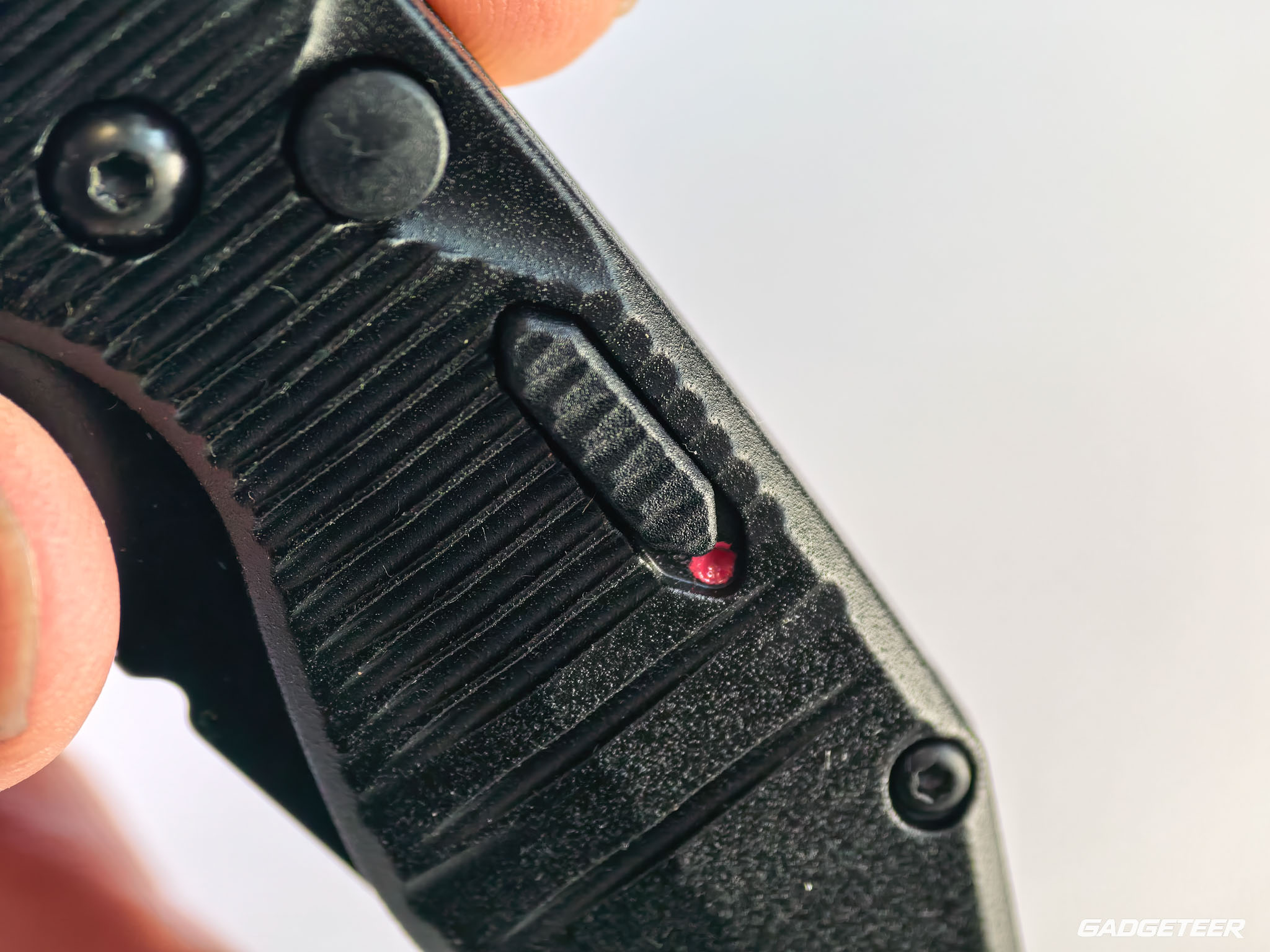 Safety slider and blade-release button beside the button-lock description