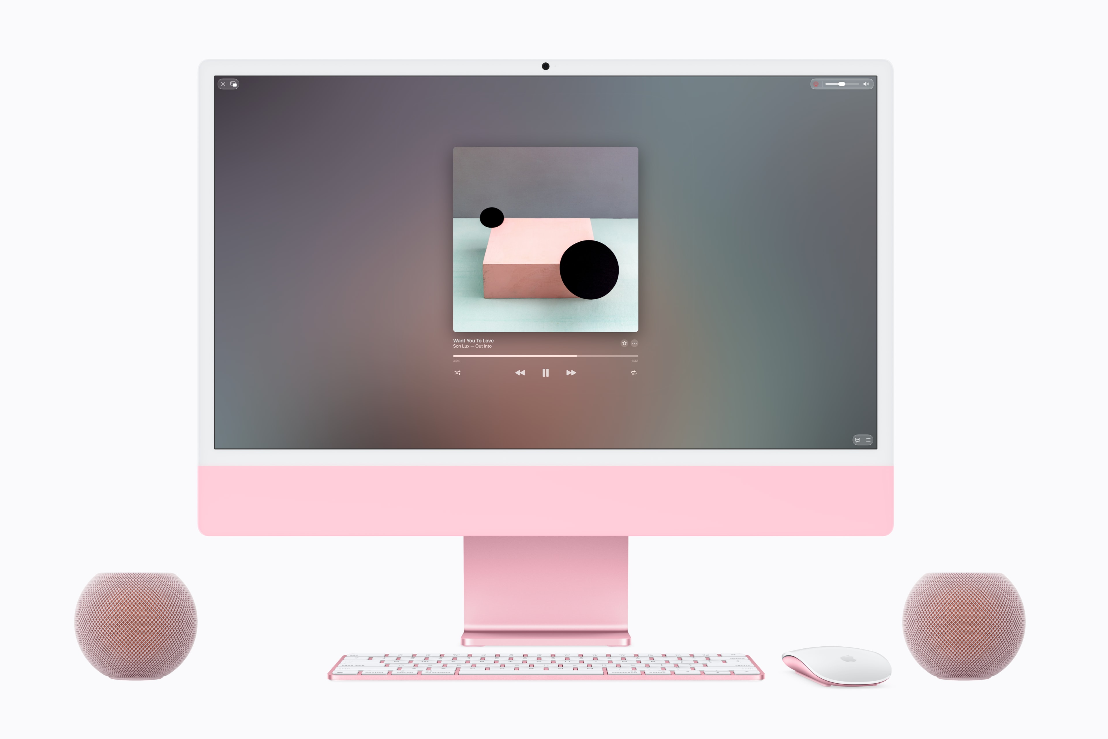Two HomePod mini 2 speakers alongside an iMac.