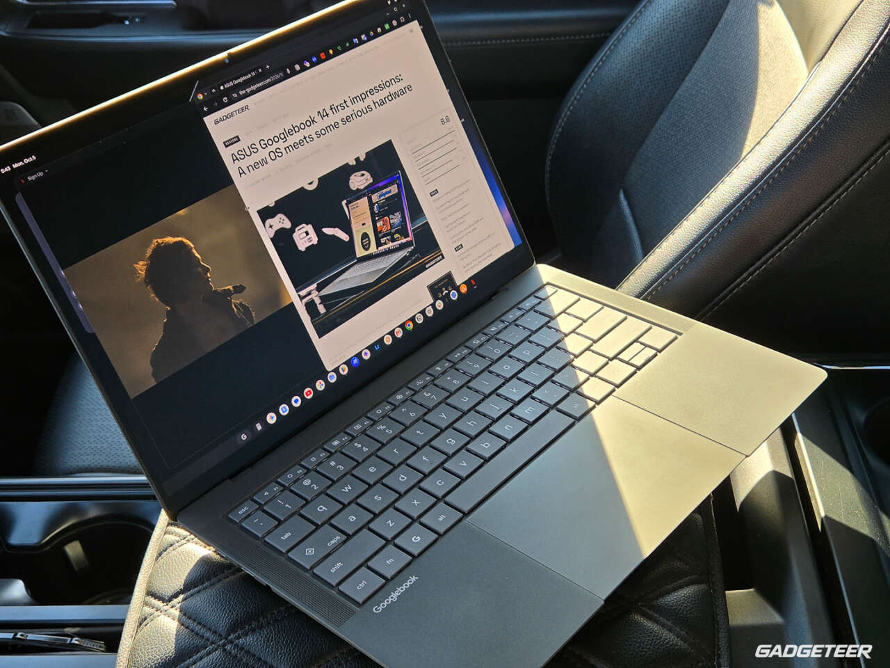 ASUS Googlebook 14 open in a sunlit parked car, showing The Gadgeteer beside a movie scene.