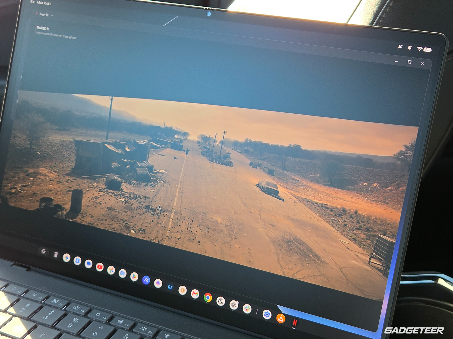 Warm orange movie scene on the ASUS Googlebook 14 display in the parked car.