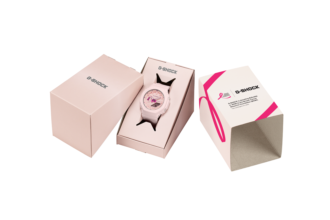 Casio Pink Ribbon G-Shock in its special-edition pink box beside the printed outer sleeve
