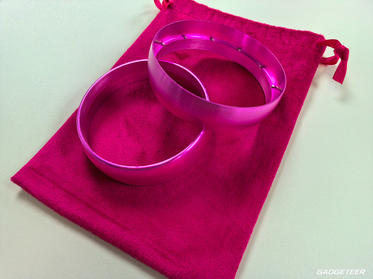 Two loose pink Chilipad remote rings on their storage pouch