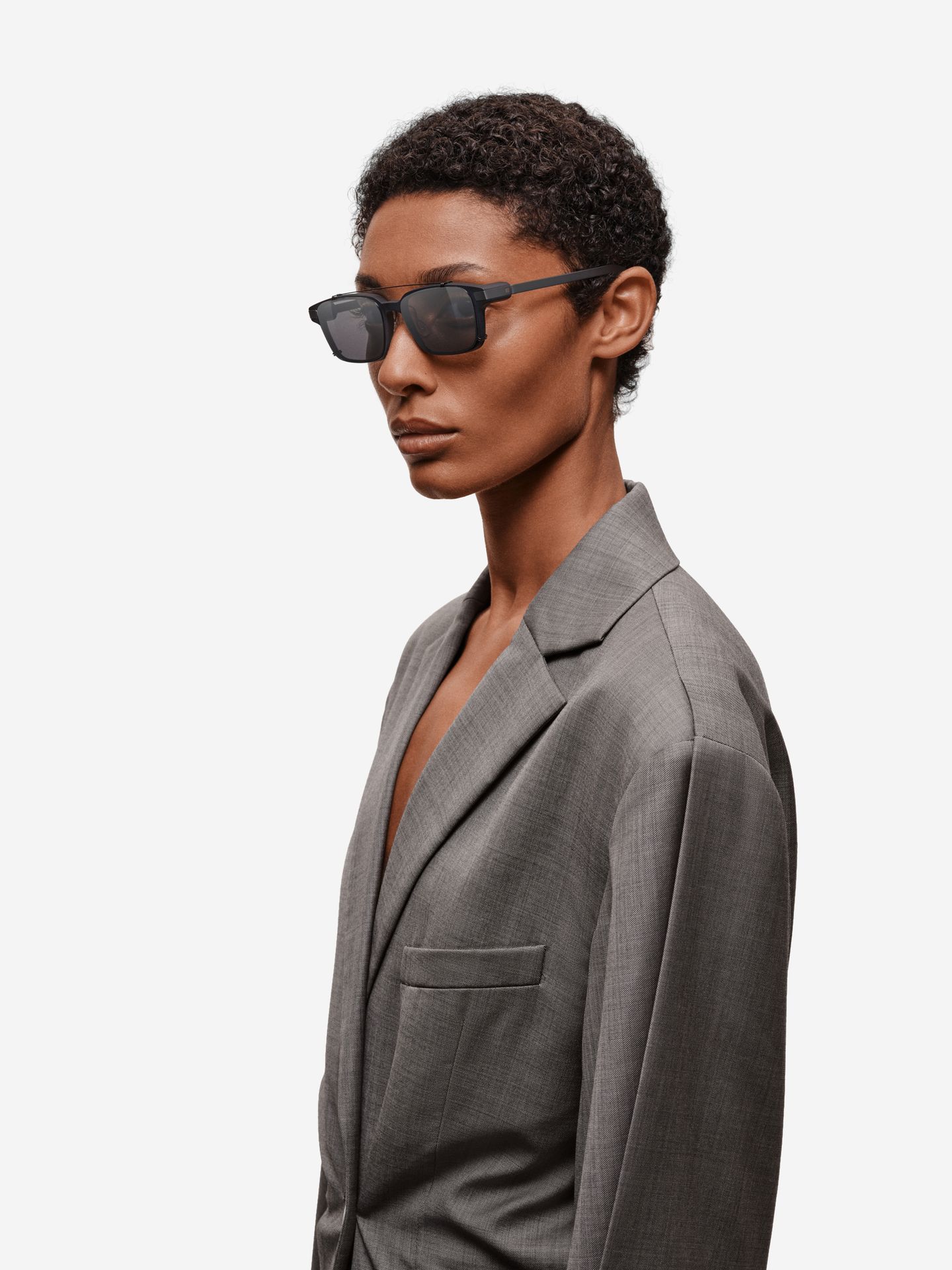 Model wearing rectangular Even G2 glasses with the polarized clip attached