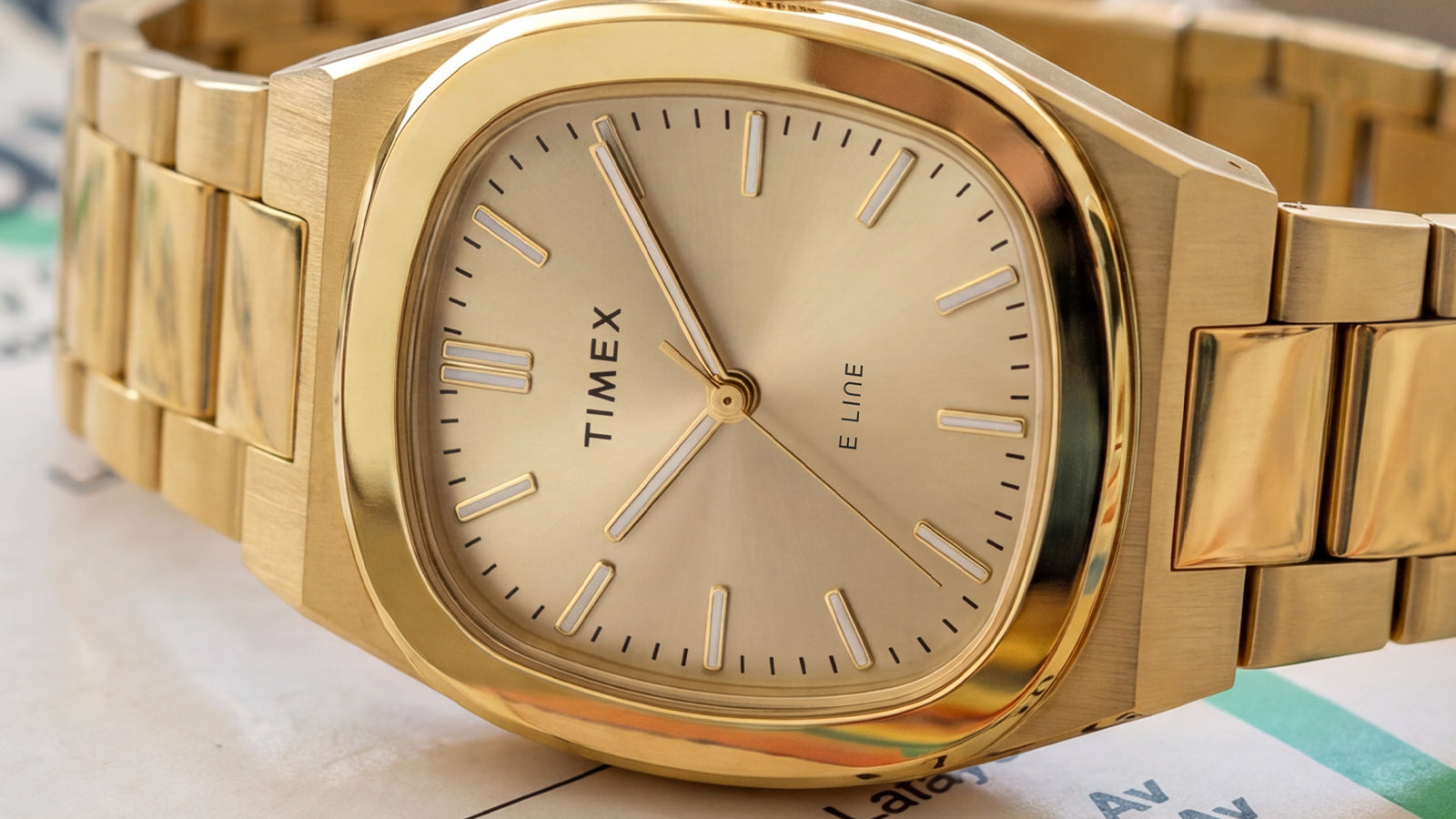 Close-up of the Timex E Line champagne dial and rounded-square gold-tone case