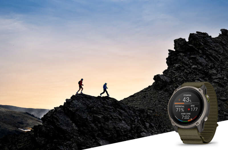 Garmin Enduro 4 with trail runners in a rocky landscape