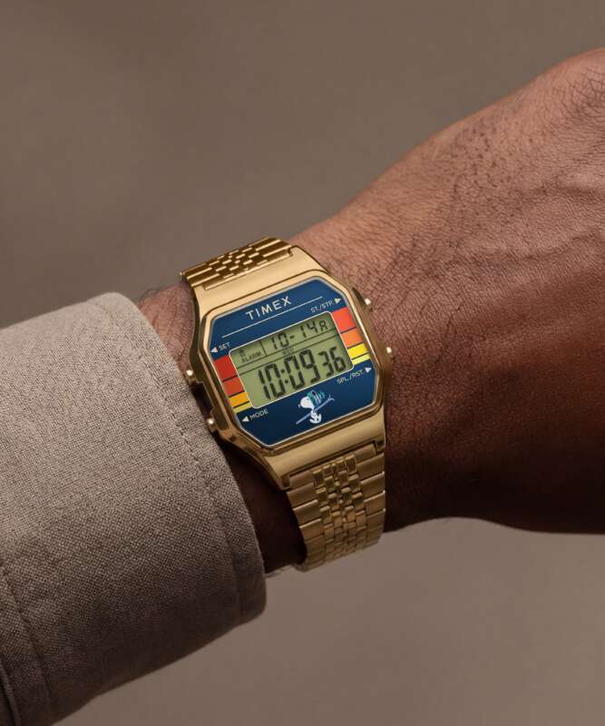 Gold-tone Timex T80 Snoopy Ski watch on a wrist