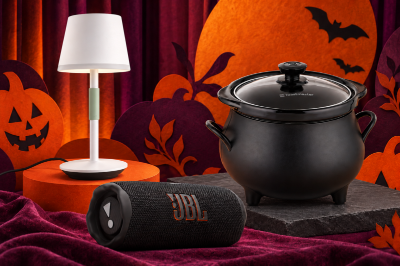 Hue Go lamp, JBL Flip 7 speaker and cauldron slow cooker arranged for a Halloween movie night