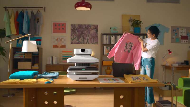 WonderPress in a colorful craft studio with a finished shirt.