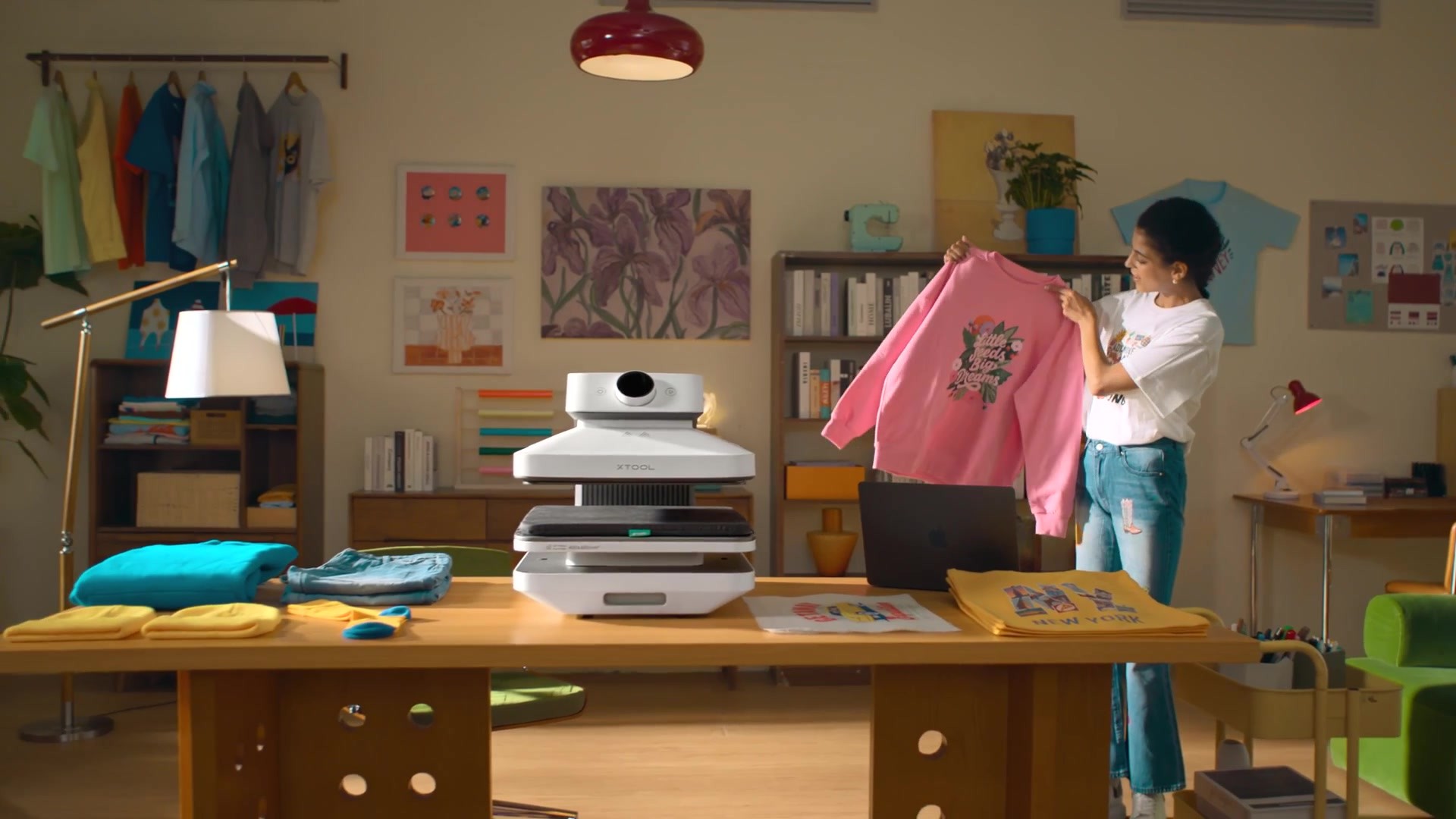 WonderPress in a colorful craft studio with a finished shirt.
