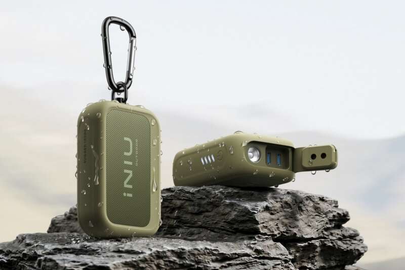 INIU Outdoor Rugged 10000 power banks in Ranger Green on rocks, with one port cover open.