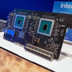Exposed accelerator boards and chips beside an Intel GPU D-series sign at Intel’s OCP booth.