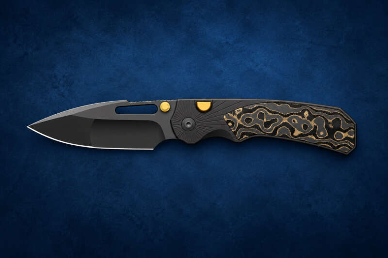 Kizer Durandal Camo Gold pocket knife on a dark blue editorial background