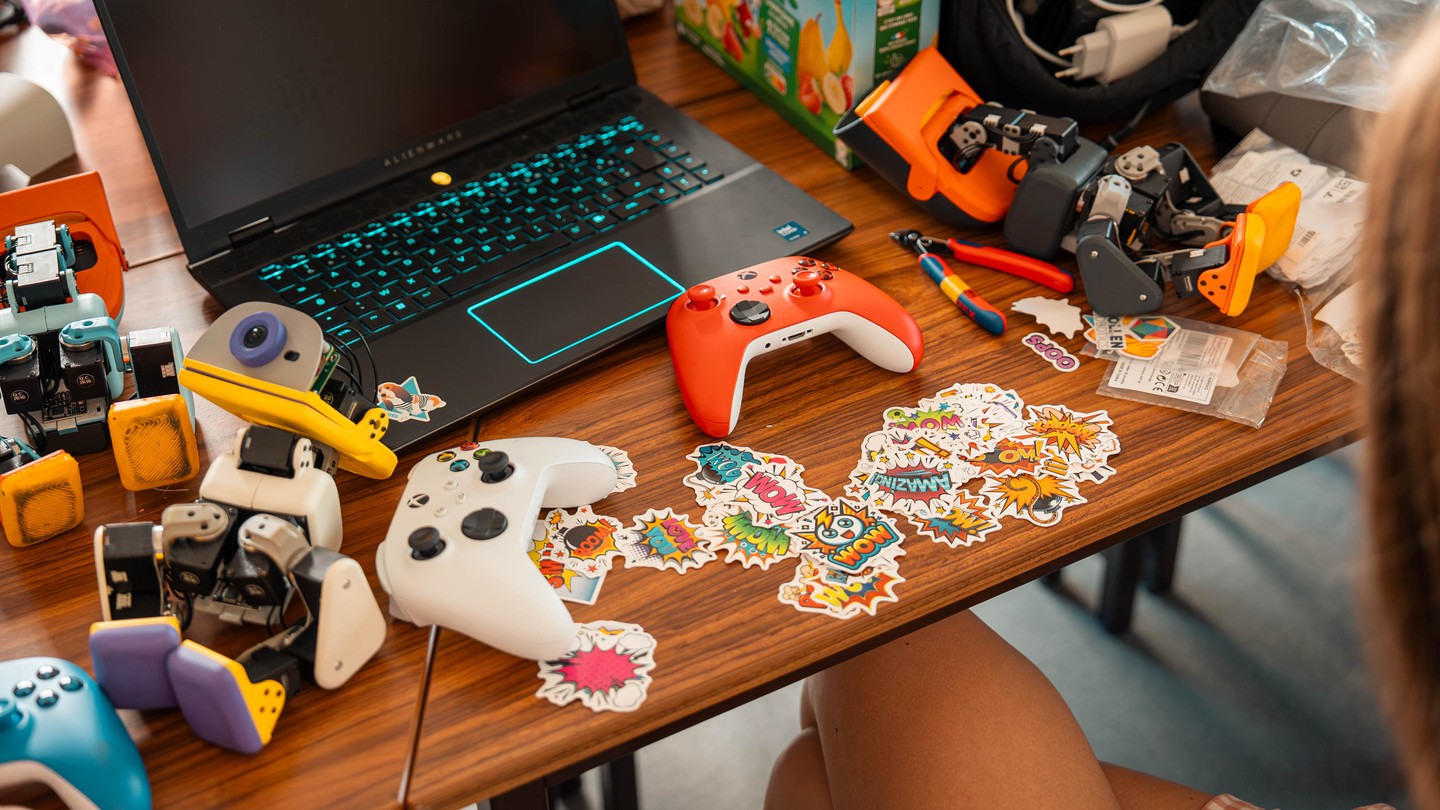 Microducks, game controllers and stickers arranged on a desk